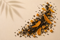Existence Brewed Flow loose-leaf mango black tea with dried mango pieces, tea leaves, and calendula petals.