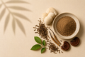 Existence Brewed Transcend hōjicha mushroom tea powder in a bowl with roasted tea leaves and assorted mushrooms.